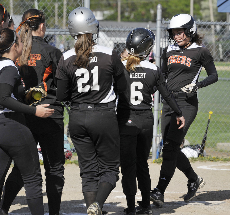 Biddeford’s Katelyn Lebreux, a senior captain, is greeted at the plate after her two-run homer in the second inning during a 7-1 win at Westbrook on Monday.