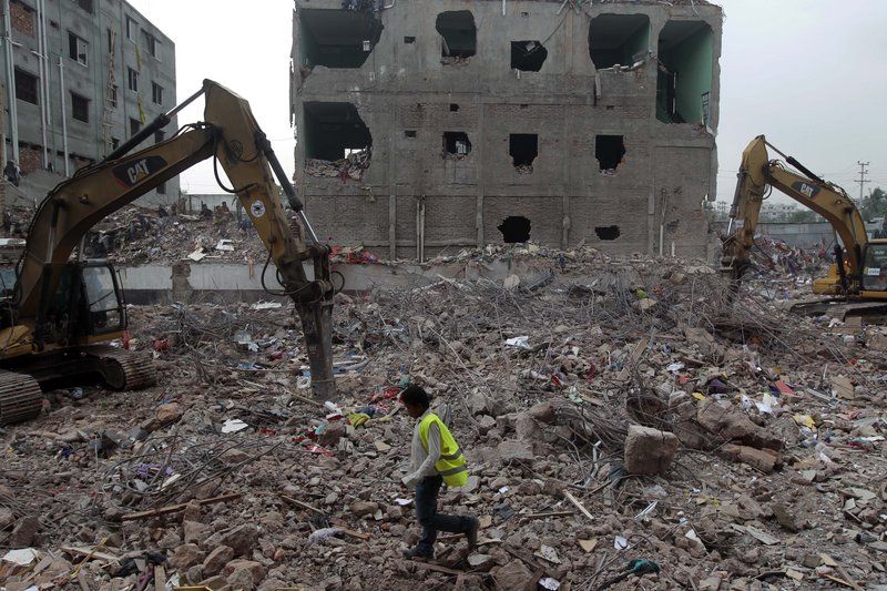 A Bangladeshi rescue worker walks at the site where a garment factory building collapsed on April 24 in Savar, near Dhaka, Bangladesh, on Monday. Nearly three weeks after the building collapse, the search for the dead ended Monday at the site of the worst disaster in the history of the global garment industry.