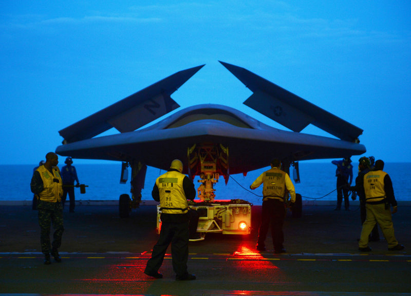 The X-47B combat drone is prepared for flight aboard the USS George H.W. Bush aircraft carrier on Monday. The X-47B, shown in a photo provided by the U.S. Navy, more closely resembles a fighter jet in size, appearance and capabilities than the much smaller drones that are currently being used by the military.