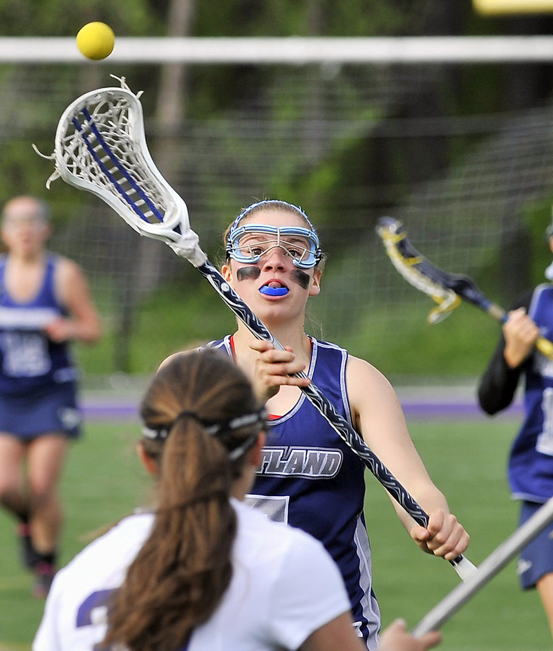 Lizzie Landry of Portland whips a pass over the head of a Deering defender. Portland improved to 6-2.