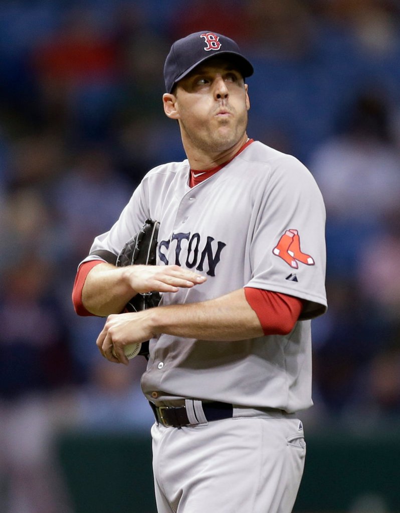 John Lackey has little to smile about Tuesday night as the Rays rock him with a five-run fourth inning en route to a 5-3 victory in St. Petersburg, Fla.