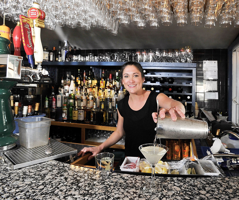 Kelsey Sirois, a waitress and bartender at Joe's Boathouse on the waterfront in South Portland, makes a Dirty Martini. The restaurant's bar is small, but in summer, an outdoor deck provides a scenic spot for sipping.