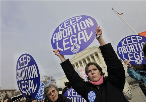 Abortion-rights activists hold up signs as anti-abortion demonstrators march toward the Supreme Court in Washington on Jan. 22, 2010, the 37th anniversary of the high court ruling that decriminalized abortion. Bills such as those now before the Maine Legislature are part of a push by opponents of abortion to chip away at women’s reproductive rights.