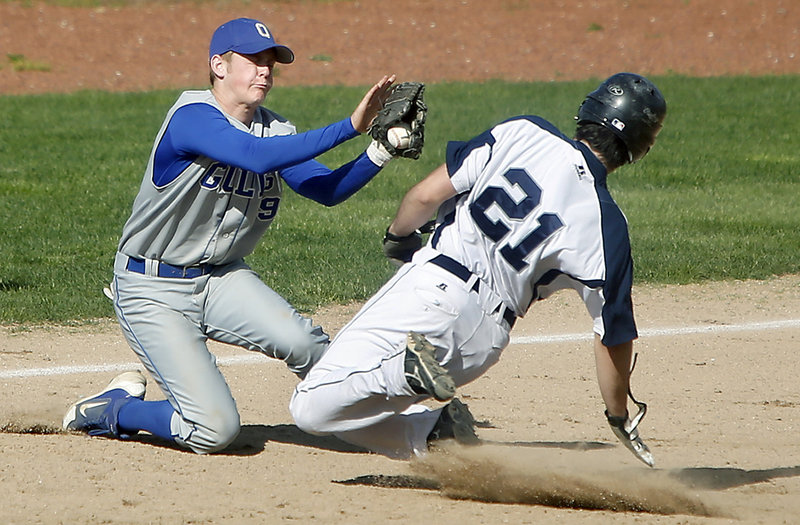 Old Orchard Beach third baseman Sean McDermott can’t hold onto the ball as Poland’s Jake Simard slides in safely Thursday. Poland scored a pair of late runs to hold off Old Orchard Beach 8-7 in the matchup between Class B and Class C teams.