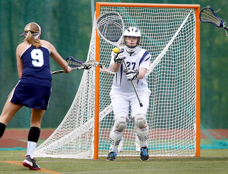 Lizzy Wagner of York watches as her shot is about to go past Yarmouth goalie Nicki Hickey in the first half Thursday. Wagner scored four goals as York took a 12-9 win.