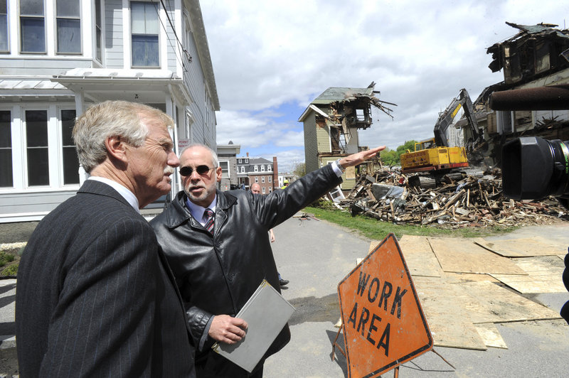 U.S. Sen. Angus King tours fire sites in Lewiston, including 80-82 Pine St., where he was briefed by Assistant City Administrator Phil Nadeau.