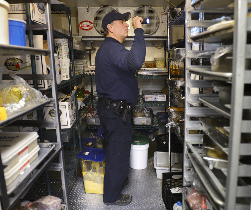 Scott Davis, a state health inspector, checks a walk-in cooler at the Stage Neck Inn in York Harbor. The Legislature scaled back the frequency of restaurant inspections to once every two years, making Maine’s rule among the most lax in the nation. Many other states require multiple inspections each year.
