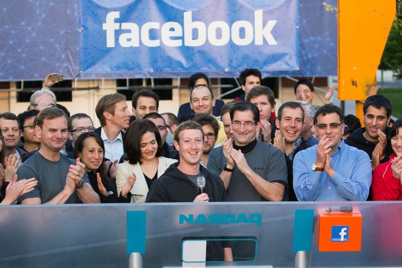 Facebook founder, Chairman and CEO Mark Zuckerberg, center, rings the opening bell of the Nasdaq stock market a year ago from Menlo Park, Calif.