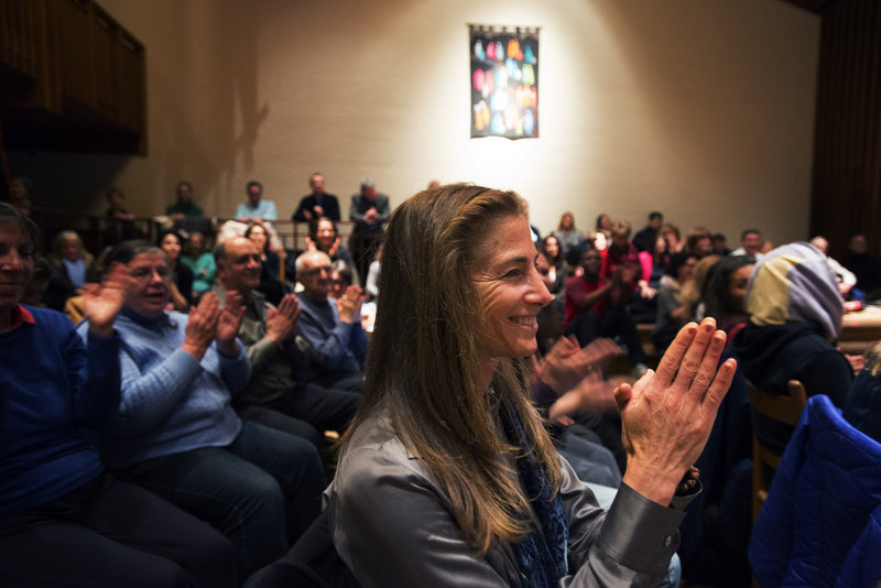 Tara Brach applauds a music performance at the Maryland church where she holds a weekly meditation class.