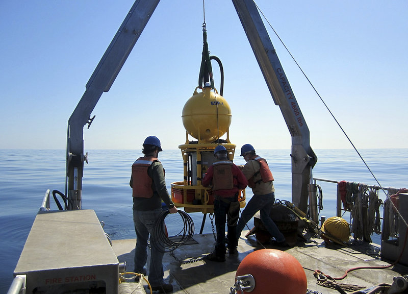 A robotic device is deployed April 28 in the ocean off southern Maine to collect and transmit data about the toxin-producing algae blooms known as red tide.