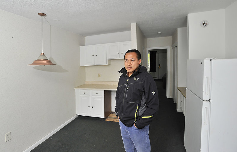 Tim Ly, the owner of MaineLy Property Management, talks about his efforts to satisfy safety requirements in the Route 1 apartment complex he manages. He’s standing in one of the rooms that need upgrading so he can get an occupancy permit.