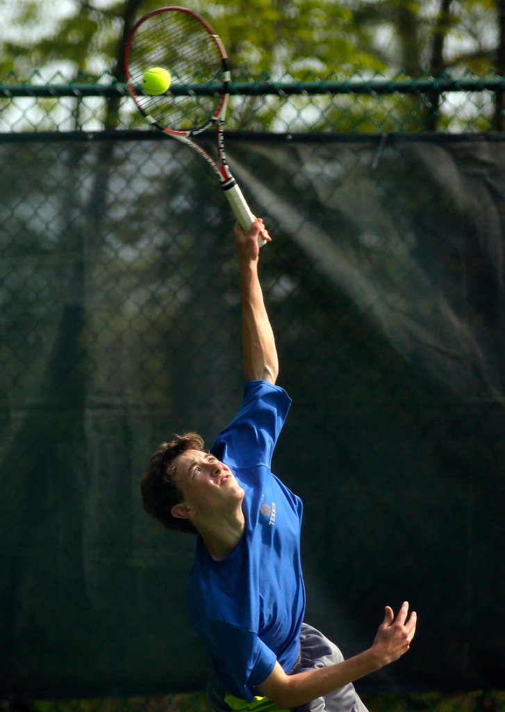 Brendan McCarthy of Falmouth winds up for a serve against Patrick Ordway. Falmouth lost at No. 1 and No. 2 singles but swept the doubles matches.