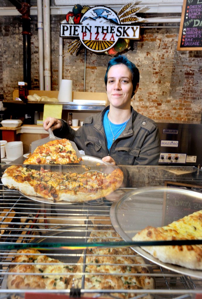Veronica Smith readies a slice of pizza at Pie in the Sky Pizza at the Public Market building in Portland's Monument Square.