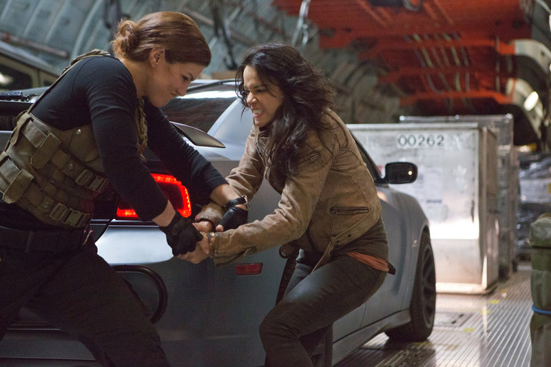 Gina Carano, left, and Michelle Rodriguez grapple in the latest of the “Fast & Furious” action films.