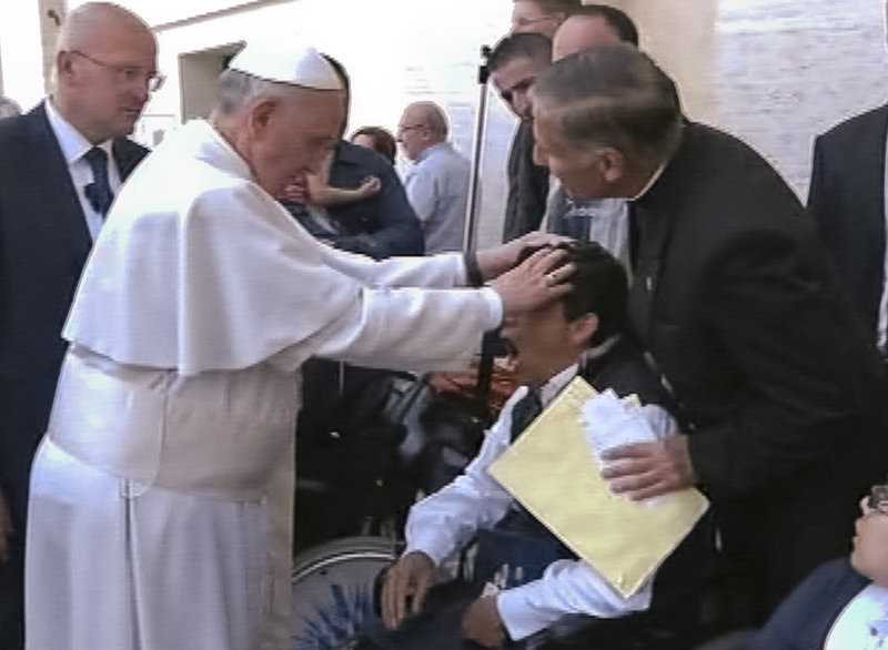 Pope Francis lays his hands on a man’s head after celebrating Mass on Sunday. Experts say he either performed an exorcism or a said a prayer to free the man from the devil.
