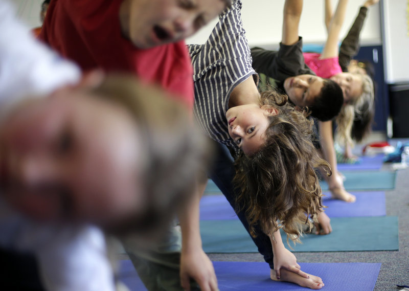 Students appear to take seriously their yoga class at Capri Elementary School in Encinitas, Calif. Experts would like schools to make physical education a core subject.