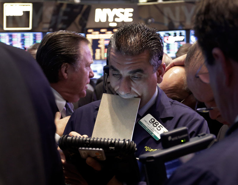 Trader Vincent Quinones works on the floor of the New York Stock Exchange at the close of trading Thursday.