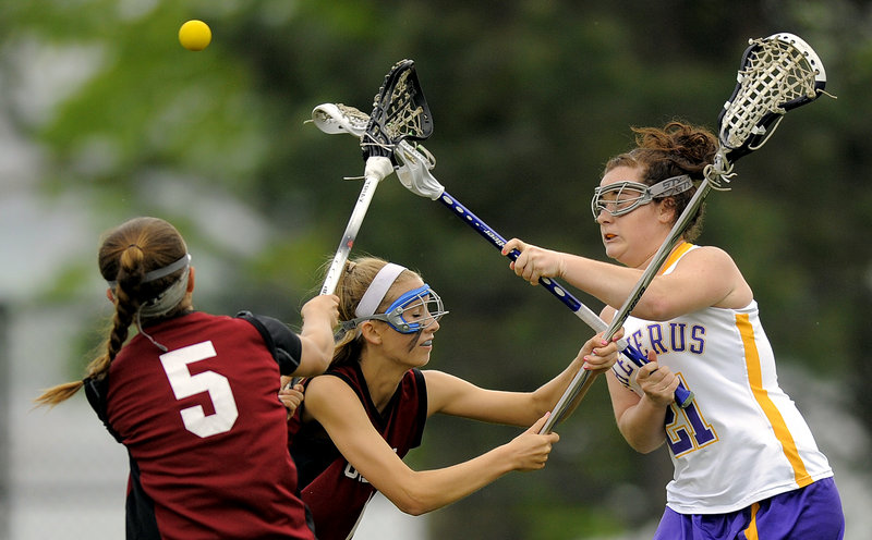 MaryKate Walsh of Cheverus, right, gets a shot off over two Gorham defenders, including Jackson Marshall, 5. Cheverus bounced back from a loss to Thornton Academy.