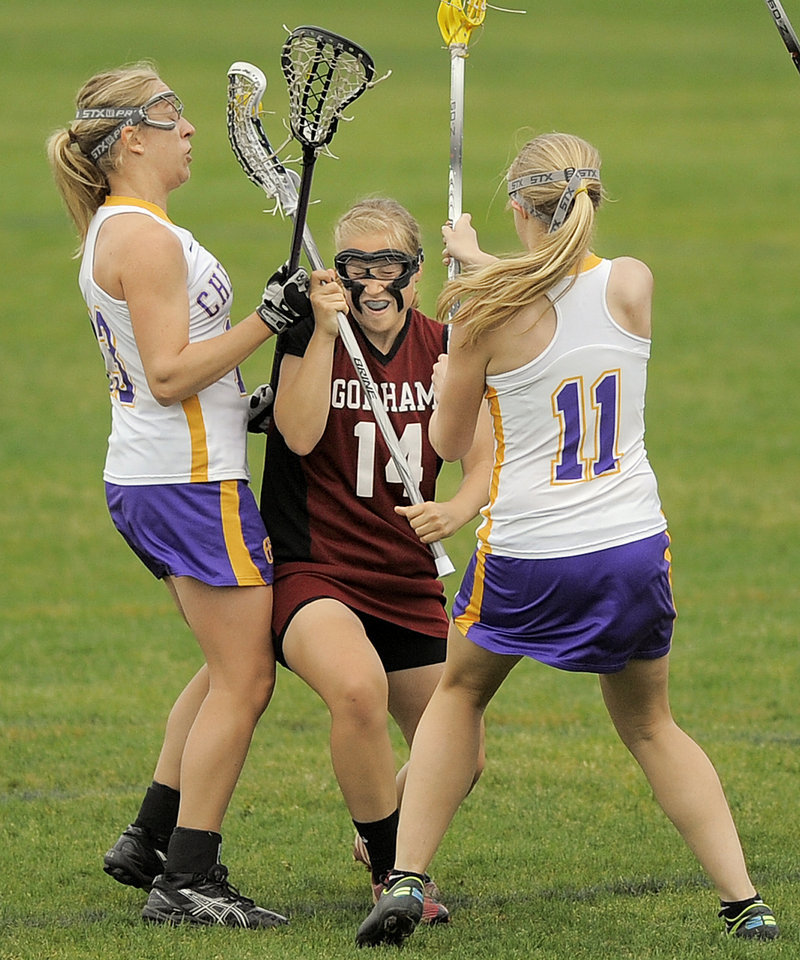 Meghan Cushing of Gorham looks to advance between Alex Logan, left, and Mary Kate Slattery of Cheverus during Cheverus’ 14-12 victory Thursday in schoolgirl lacrosse.