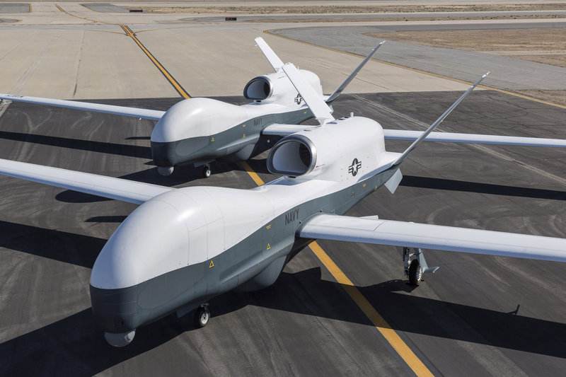 Two Northrop Grumman MQ-4C Triton drones are seen on the tarmac at a Northrop Grumman test facility in Palmdale, Calif., on Wednesday.