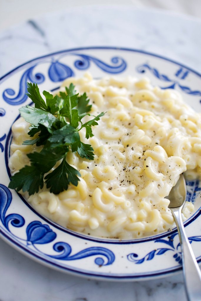 Modernist macaroni and cheese benefits from a new approach to making a cheesy sauce that bypasses the flour, butter and milk used in a Mornay sauce. This recipe uses white cheddar, but cooks can substitute their favorite cheeses.