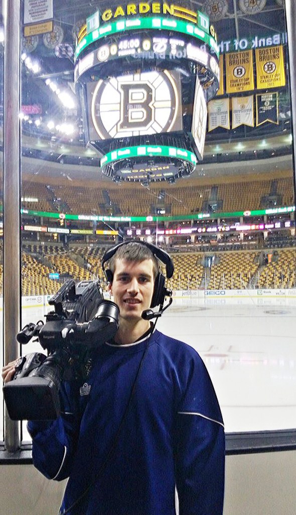 Maxx Coombs, with his camera, before a Bruins' game at TD Garden.
