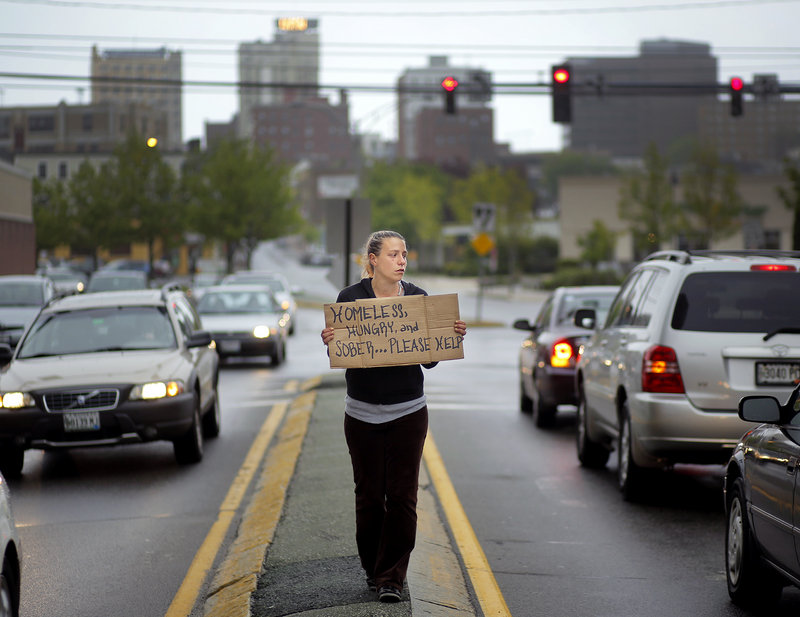Alison Prior, 29, of Portland, panhandles for change at the corner of Preble Street and Marginal Way on Friday, May 24, 2013. Prior says she panhandles for extra money while she and her boyfriend look for an apartment.