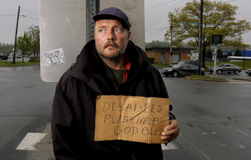 Don Dietz, 48, panhandles for change in the median at the corner of Franklin Street and Marginal Way on Friday, May 24, 2013.