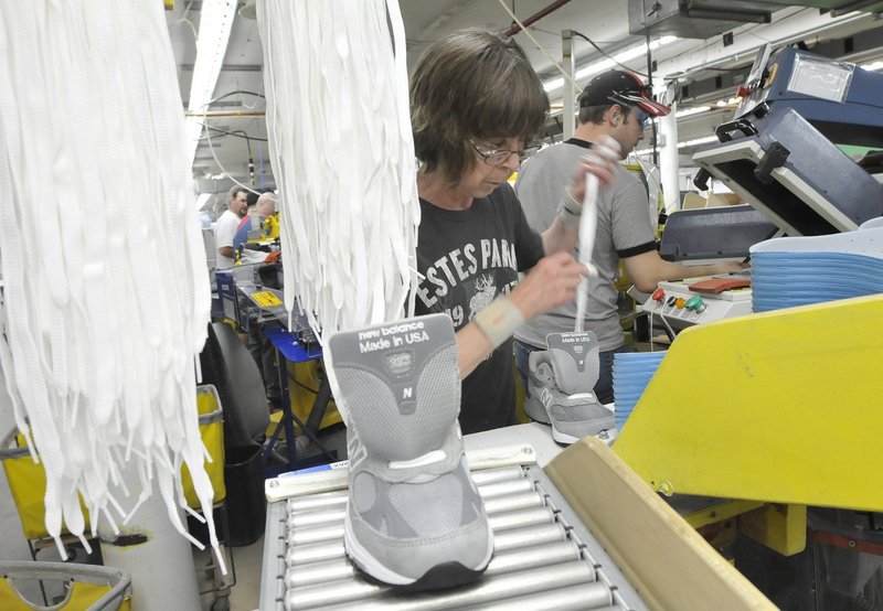 Sharon Estes laces shoes at New Balance’s Norridgewock factory. The company employs roughly 900 people in factories in Norridgewock, Skowhegan and Norway, Maine.
