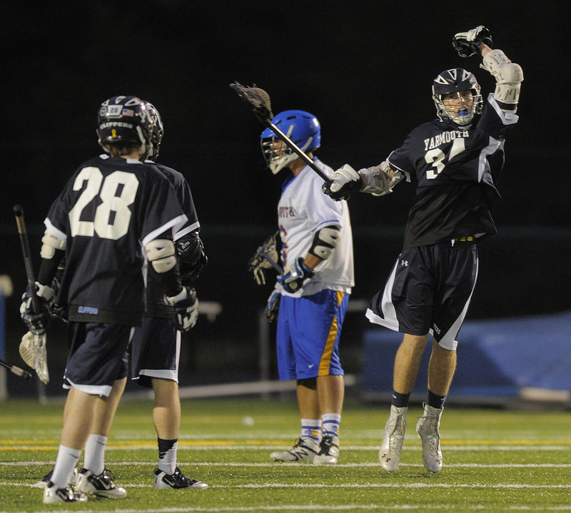 Christian Henry of Yarmouth celebrates Friday night after scoring one of his team-high four goals in a 15-14 overtime victory over Falmouth.