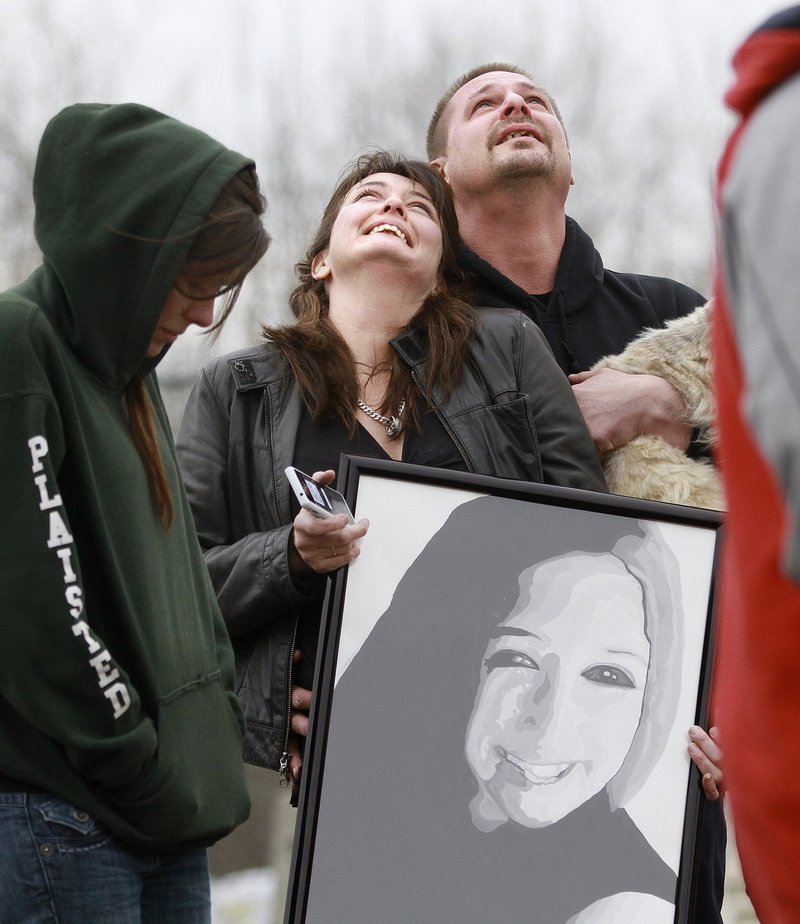 Haley Plaisted’s mother, Rebecca Liberty of Shapleigh, accompanied by her boyfriend, David Pillsbury, watches as balloons rise in tribute to the daughter she lost early last month. Liberty is holding a portrait of Haley that was created by the teen’s classmates at Sanford High School.