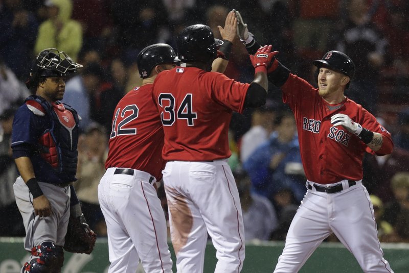 Boston’s Mike Carp, right, is congratulated by Mike Napoli (12) and David Ortiz (34) after his three-run homer in the second inning off Cleveland starter Justin Masterson that helped spark the Red Sox to a convincing 8-1 victory at Fenway Park.