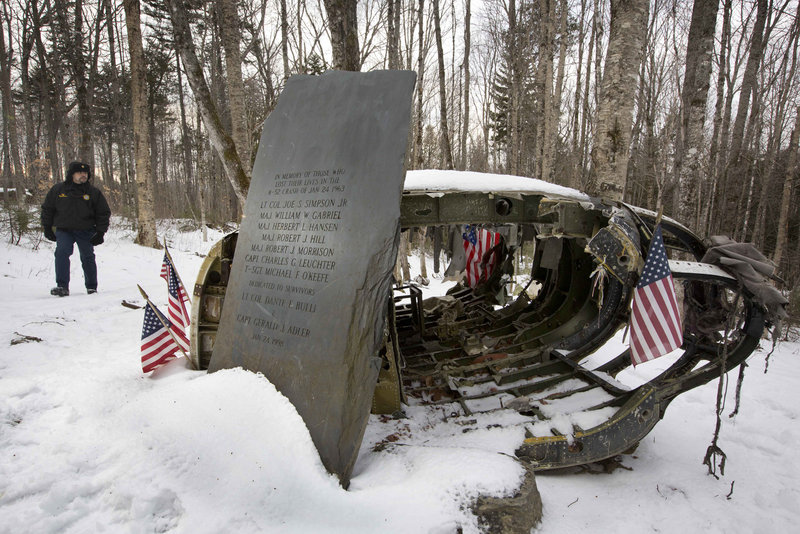 Greenville Police Chief Jeff Pomerleau views a monument near wreckage of a B-52 bomber on Elephant Mountain in this 2012 photo. The plane’s vertical stabilizer snapped off, and the crash in January 1963 killed seven of the nine people on board. Air Force personnel from around the country gathered in Greenville on Saturday to remember the deadly crash.