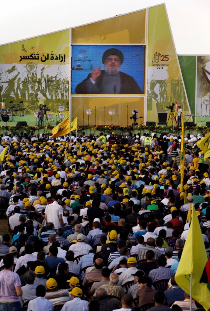Sheikh Hassan Nasrallah talks Saturday in Mashghara, Lebanon. He said Hezbollah members are fighting in Syria against Islamic radicals who pose a danger to Lebanon.