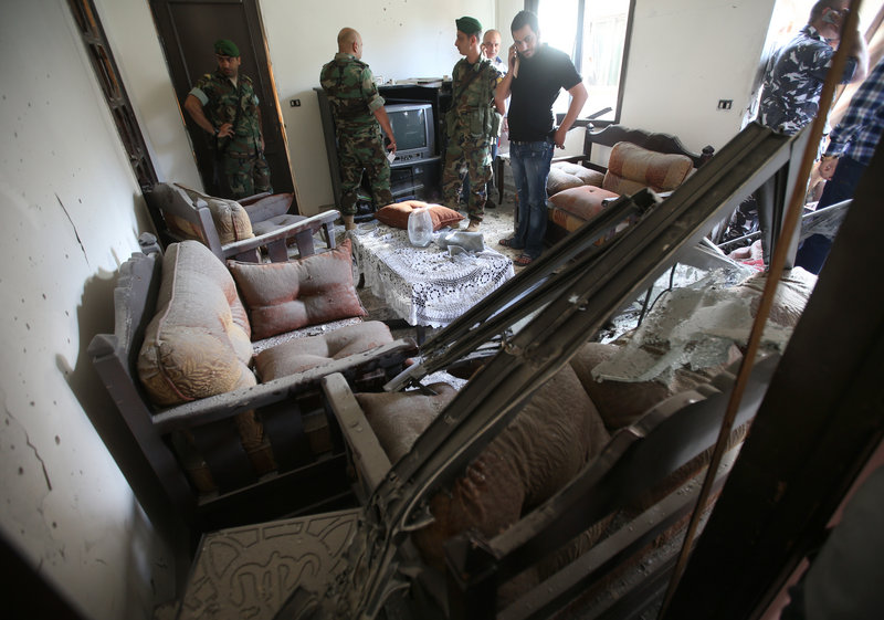 Lebanese army soldiers investigate after a rocket struck an apartment in Chiyah district, south of Beirut, Lebanon, on Sunday.