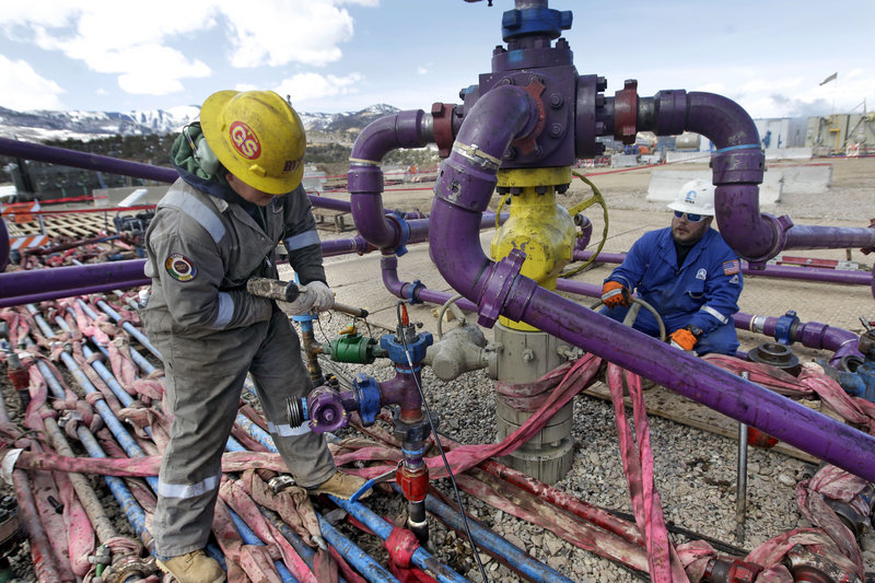 Workers tend to a well head at a hydraulic fracturing, or fracking, operation in Colorado. General Electric hopes its research can help reduce environmental impacts of the drilling.