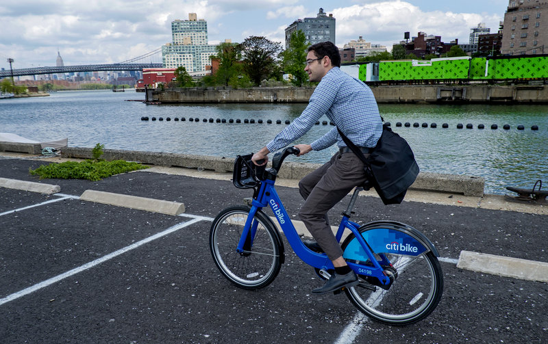 Alex Engel, with New York City Department of Transportation, rides a bike-sharing bicycle in New York.
