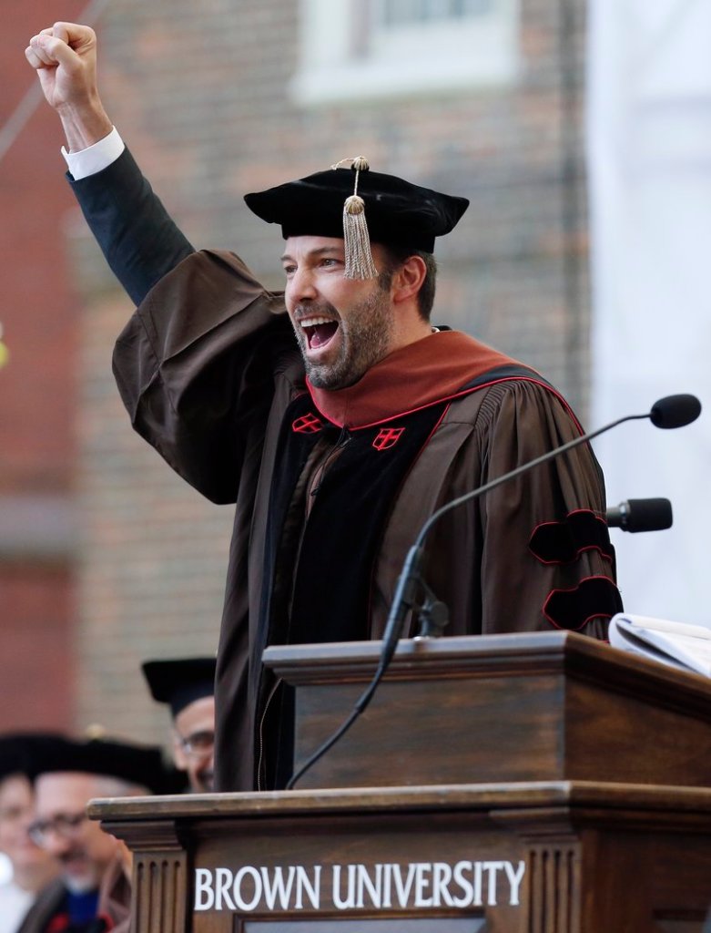 Actor and director Ben Affleck raises his fist after receiving an honorary degree from Brown University.