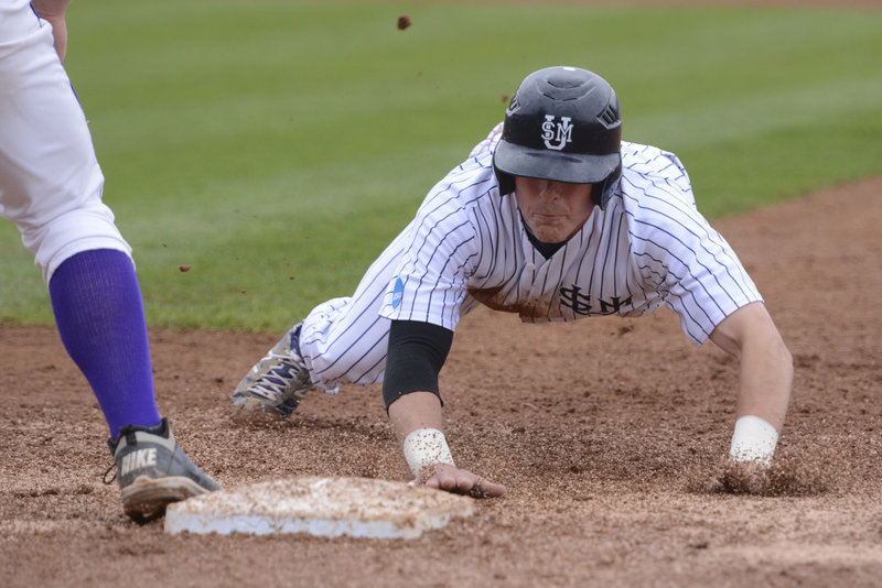 Troy Thibodeau of USM dives back safely to first on a pickoff attempt in Monday’s game at the NCAA Division III championships in Appleton, Wisc. USM advanced with an 8-1 win over Wisconsin-Stevens Point.