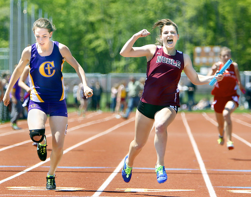 Dakotah Clement of Noble celebrates after edging Sarah Mount of Cheverus to give her team the victory Monday in the 400-meter relay at the SMAA track and field championships in Saco. Noble’s time was 51.18 seconds, while Cheverus finished in 51.33.