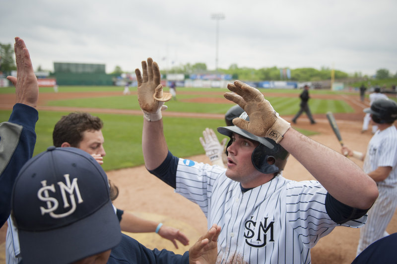 Chris Bernard gets a welcome reception in the Southern Maine dugout after scoring in the sixth inning Monday.