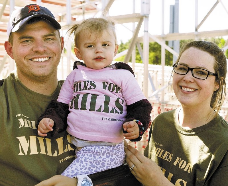 Staff Sgt. Travis Mills with daughter Chloe and wife Kelsey Buck Mills at Cony High School in Augusta.