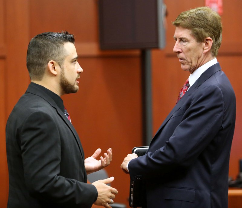 Robert Zimmerman Jr., left, the brother of George Zimmerman, the accused shooter of Trayvon Martin, talks with defense lawyer Mark O’Mara in a Florida court Tuesday.
