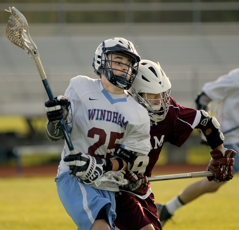 Bryce Rolfe of Windham braces for the impact he receives on a hit by Frank Pappalardo of Gorham during their game.