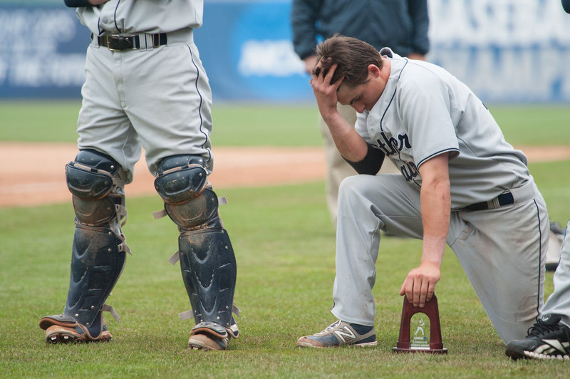 USM’s Troy Thibodeau kneels during the trophy ceremony after the Huskies lost the Division III national championship game Tuesday against Linfield (Ore.) College.