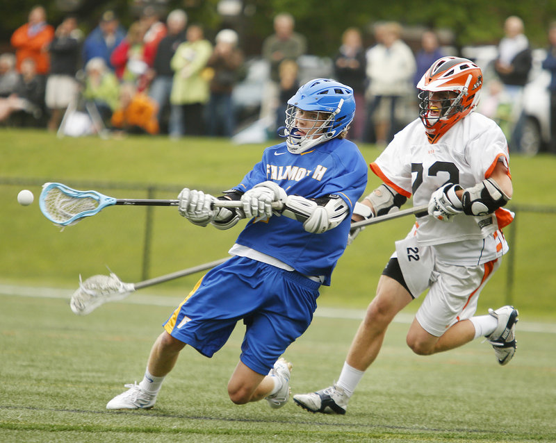 IV Stucker of Falmouth scores a fourth-quarter goal after slipping past Adrian McLaughlin of North Yarmouth Academy.