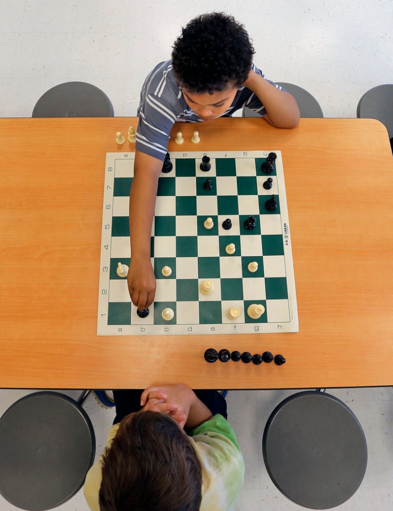 Gianni Aviles, top, a third-grader at East End Community School in Portland, makes his move during a chess match vs. Owen Davis, a Falmouth third-grader, Wednesday, May 29, 2013, at East End School's inaugural chess match.