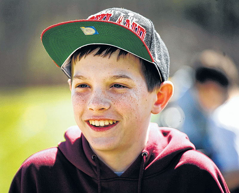 Matthew Freitas, 12, is all smiles as he watches his lacrosse team on the field. He would like to let others know that having an amputation need not destroy your dreams.