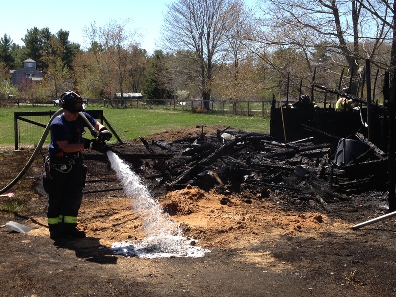 Saco firefighters work at the scene of a fire that destroyed a barn Tuesday.