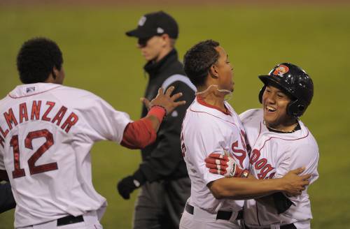 Heiker Meneses, right, is greeted by Xander Bogaerts as Michael Almanzar rushes in Wednesday night. Meneses singled in the winning run in the 10th inning as the Portland Sea Dogs defeated the New Hampshire Fisher Cats 5-4 at Hadlock Field.